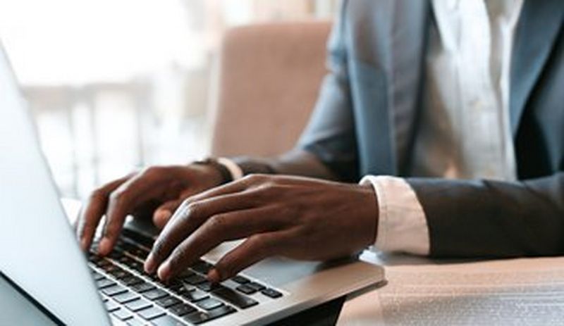 Hands working at a laptop